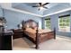 This spacious main bedroom features neutral carpet, a ceiling fan, and lots of natural light at 5292 Windfield Glen Nw Ct, Lilburn, GA 30047