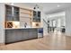 Stylish bar area with sink, beverage cooler, glass shelving, and a view into the game room at 126 Owens Mill Pl, Canton, GA 30115