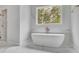 Contemporary bathroom with marble floors, large window, and freestanding tub at 126 Owens Mill Pl, Canton, GA 30115