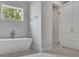 Modern bathroom featuring a freestanding tub, a walk-in shower and marble floors at 126 Owens Mill Pl, Canton, GA 30115