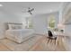 Light and airy bedroom featuring hardwood floors, shutters, ceiling fan, and a small desk at 126 Owens Mill Pl, Canton, GA 30115
