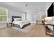 Airy bedroom with hardwood floors, a comfortable bed, and natural light from the windows at 126 Owens Mill Pl, Canton, GA 30115