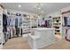 Spacious walk-in closet with ample storage, custom shelving, and an elegant chandelier at 126 Owens Mill Pl, Canton, GA 30115