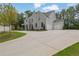 Expansive driveway leading up to a gorgeous stone home with a two-car garage at 126 Owens Mill Pl, Canton, GA 30115