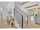 Elegant foyer boasts staircase with modern railing, wood floors, decorative beams, and natural light at 126 Owens Mill Pl, Canton, GA 30115