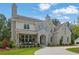 Beautiful stone home showcasing a manicured lawn and covered porch area at 126 Owens Mill Pl, Canton, GA 30115