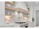 Modern kitchen featuring an open shelving design, stainless appliances, pot filler, and a tiled backsplash at 126 Owens Mill Pl, Canton, GA 30115