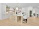 Elegant kitchen featuring island with seating, white cabinets, stainless appliances, and views of the dining room at 126 Owens Mill Pl, Canton, GA 30115