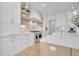 Bright and airy kitchen features stainless appliances, white cabinets, open shelving, and modern design at 126 Owens Mill Pl, Canton, GA 30115
