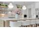 Modern kitchen boasts stainless appliances, island with seating, pendant lights, and stylish backsplash at 126 Owens Mill Pl, Canton, GA 30115