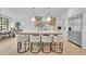 Stylish kitchen features island with seating, stainless appliances, and bright natural light from nearby dining area at 126 Owens Mill Pl, Canton, GA 30115