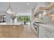 Modern kitchen featuring white cabinets, and large island with quartz countertop at 126 Owens Mill Pl, Canton, GA 30115