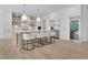 Spacious kitchen features stainless appliances, white cabinetry, a large island with seating, and wood flooring at 126 Owens Mill Pl, Canton, GA 30115