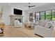 Bright living room with a stone fireplace, hardwood floors, and backyard views at 126 Owens Mill Pl, Canton, GA 30115