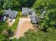 An aerial view of a home with a long driveway, lawn and surrounding greenery at 3100 Mount Gilead Sw Rd, Atlanta, GA 30311
