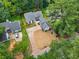 An aerial view of a home's roof, long driveway, front yard and surrounding greenery at 3100 Mount Gilead Sw Rd, Atlanta, GA 30311