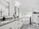Modern bathroom features dual sinks, soaking tub, and walk-in shower at 3100 Mount Gilead Sw Rd, Atlanta, GA 30311