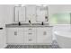 Well-lit bathroom features double vanity, soaking tub, and modern finishes at 3100 Mount Gilead Sw Rd, Atlanta, GA 30311