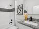 Bathroom featuring a bathtub and shower with a decorative backsplash and a granite countertop sink at 3100 Mount Gilead Sw Rd, Atlanta, GA 30311