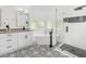 Bright bathroom featuring a soaking tub, patterned tile floor, and a glass-enclosed shower at 3100 Mount Gilead Sw Rd, Atlanta, GA 30311