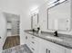 Bathroom with a dual sink vanity, granite countertop, and patterned floor tiles at 3100 Mount Gilead Sw Rd, Atlanta, GA 30311