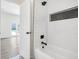 Bathroom with white subway tile, black fixtures, and a decorative inset niche at 3100 Mount Gilead Sw Rd, Atlanta, GA 30311