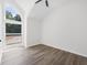 Minimalist bedroom with vaulted ceilings and large arched window overlooking trees at 3100 Mount Gilead Sw Rd, Atlanta, GA 30311