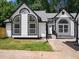 Charming home featuring black trim, arched windows, and a freshly landscaped yard with lush grass at 3100 Mount Gilead Sw Rd, Atlanta, GA 30311