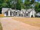 Charming home featuring black trim, arched windows, and a freshly landscaped yard with a large driveway at 3100 Mount Gilead Sw Rd, Atlanta, GA 30311