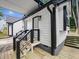 Backyard wood porch with metal railing and dark trim with painted white siding at 3100 Mount Gilead Sw Rd, Atlanta, GA 30311