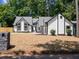 Charming home featuring black trim, arched windows, and a freshly landscaped yard at 3100 Mount Gilead Sw Rd, Atlanta, GA 30311