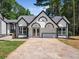 Charming home exterior with a symmetrical design, black trim, and a spacious driveway at 3100 Mount Gilead Sw Rd, Atlanta, GA 30311