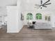 Bright living room with luxury vinyl plank flooring, arched windows, fireplace, and recessed lighting at 3100 Mount Gilead Sw Rd, Atlanta, GA 30311
