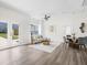 Open-concept living and dining area with modern decor, white walls, and vinyl flooring at 3100 Mount Gilead Sw Rd, Atlanta, GA 30311