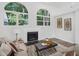 Bright living room featuring arched windows, fireplace, modern decor, and luxury vinyl plank flooring at 3100 Mount Gilead Sw Rd, Atlanta, GA 30311
