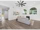 Bright living room with luxury vinyl plank flooring, arched windows, modern ceiling fan, and recessed lighting at 3100 Mount Gilead Sw Rd, Atlanta, GA 30311