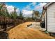 The large backyard has a cement patio and a wood fence at 3430 Summerpoint Xing, Cumming, GA 30028