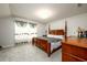 This bedroom features a four poster bed, gray carpet, and light coming in from the window at 3430 Summerpoint Xing, Cumming, GA 30028