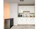 This kitchenette features white cabinets, granite countertops, and a stainless steel mini refrigerator for convenience at 3430 Summerpoint Xing, Cumming, GA 30028