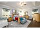 Spacious main bedroom features a tray ceiling, stylish decor, and hardwood floors, creating a luxurious retreat at 3430 Summerpoint Xing, Cumming, GA 30028