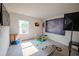 Bright bedroom featuring ample natural light, a television, and toys at 6827 Chataran Dr, Lithia Springs, GA 30122