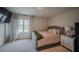 Comfortable bedroom featuring a stylish bed, soft curtains, and bedside table at 6827 Chataran Dr, Lithia Springs, GA 30122