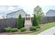 Stone monument sign at The Glen Kensington community entrance, surrounded by landscaping and a wooden fence at 6827 Chataran Dr, Lithia Springs, GA 30122