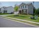 Attractive two-story home on a lush green lawn with landscaped curb appeal and a long driveway at 6827 Chataran Dr, Lithia Springs, GA 30122