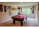 Inviting game room featuring a red felt pool table, decorative wall art, and large window at 6827 Chataran Dr, Lithia Springs, GA 30122