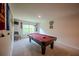 Inviting game room featuring a red felt pool table, decorative wall art, and large window at 6827 Chataran Dr, Lithia Springs, GA 30122