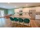 Kitchen boasts white cabinets, stainless steel appliances, and an island with bar stools at 6827 Chataran Dr, Lithia Springs, GA 30122
