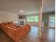 Open concept living room with hardwood floors, fireplace and oversized couch at 6827 Chataran Dr, Lithia Springs, GA 30122