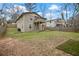 View of the home's backyard with a patio, deck, well-maintained lawn and privacy fence at 1684 Braeburn Se Dr, Atlanta, GA 30316