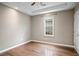 Bright bedroom featuring a ceiling fan, neutral walls, window for natural light, and a tray ceiling at 1684 Braeburn Se Dr, Atlanta, GA 30316